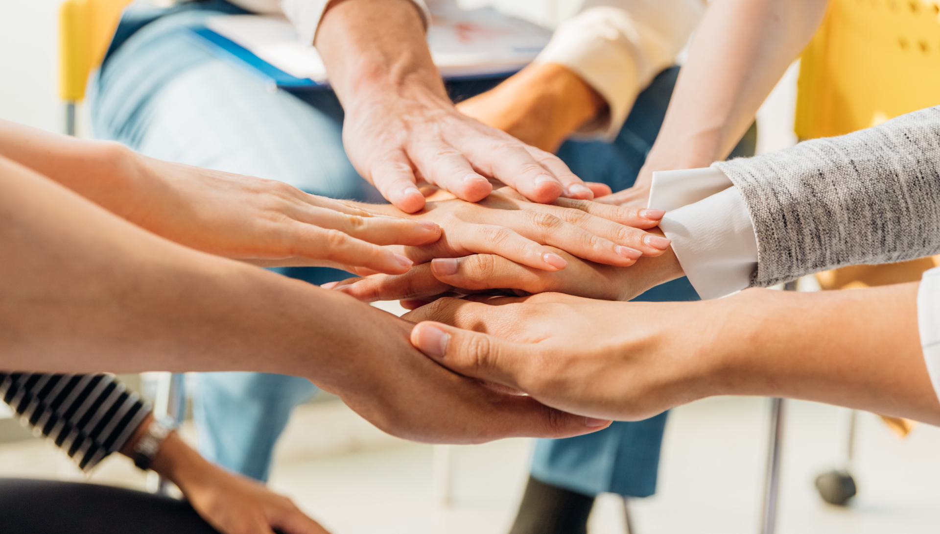 Image of several hands in the middle of a circle.